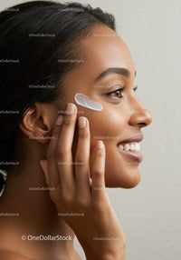 Young Woman Applying Face Cream for Healthy Skin and Natural Glow