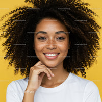 Beautiful Young Woman with Curly Hair and Freckles Against Bright Yellow Background