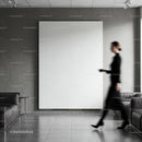 Blurred woman walking past blank minimalist canvas