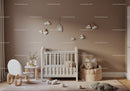 Cozy Baby Nursery with Cloud Wall Hangings and Teddy Bear Cushion