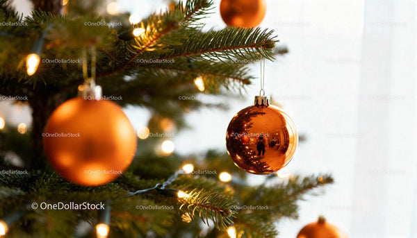 Closeup of Orange Christmas Ornaments on Fir Tree