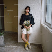 Young Woman Holding Daisy Bouquet in Bright Indoor Setting