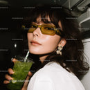 Chic Woman Wearing Yellow Sunglasses Holding Green Drink