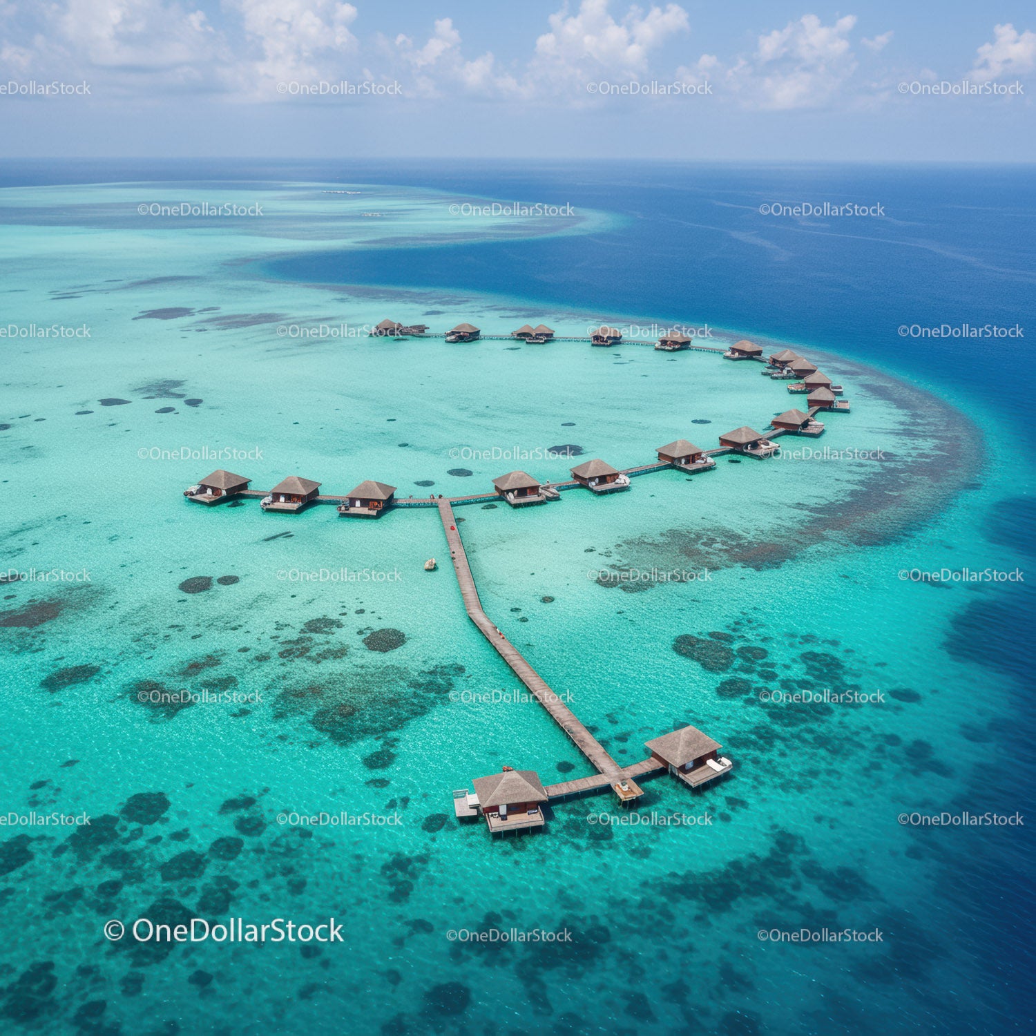 Overwater Bungalows in Clear Turquoise Lagoon Surrounded by Coral Reef