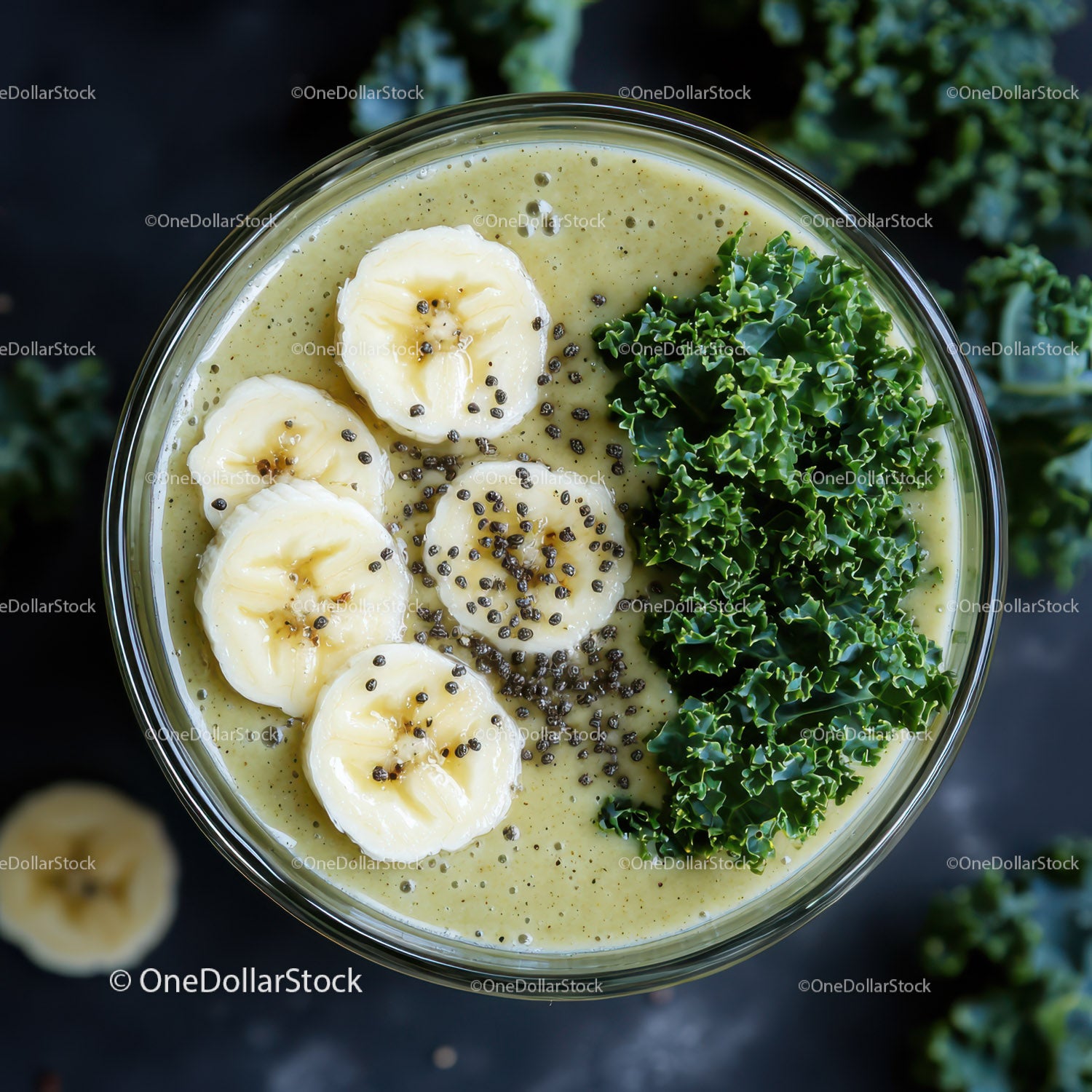 Banana and Kale Green Smoothie in Glass with Fruit Garnish