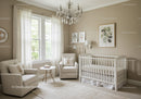 Elegant Nursery Room with White Crib and Cozy Armchair