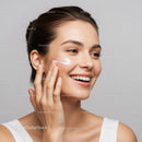 Woman Applying Facial Moisturizer for Healthy Glowing Skin