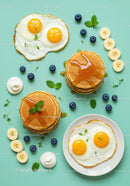 Sunny side up eggs with pancakes and fresh fruit breakfast