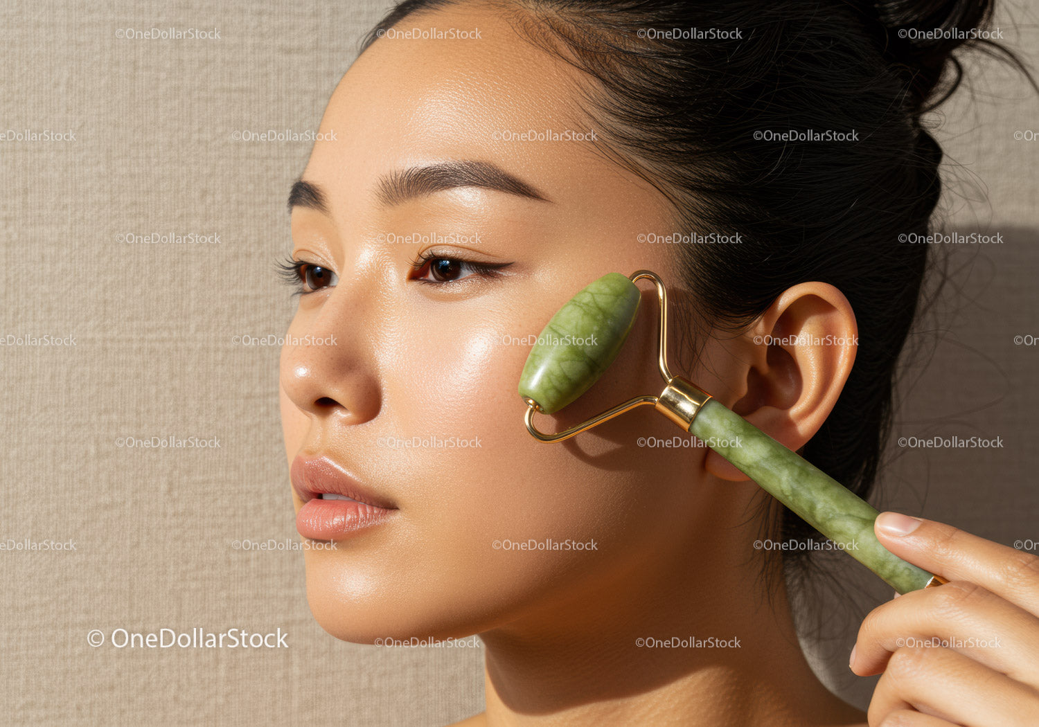 Young Woman Using Jade Facial Roller for Skincare and Relaxation