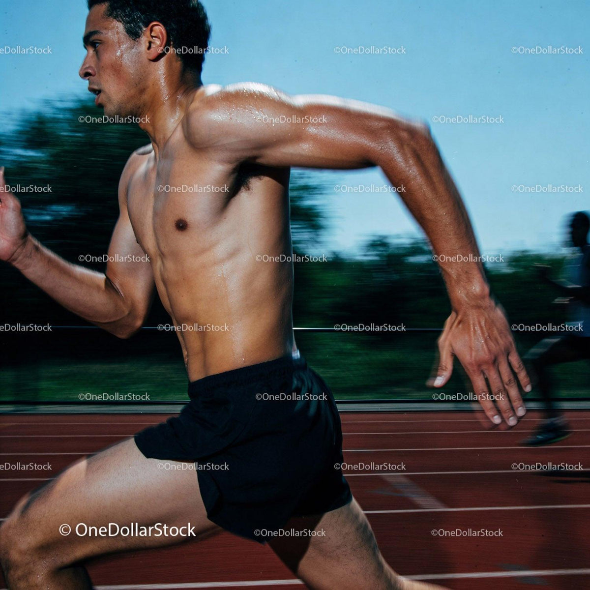 Athlete sprinting intensely on outdoor running track