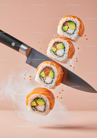 Fresh sushi rolls balanced on sharp chef knife
