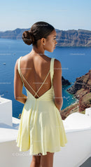Young woman in yellow dress overlooking Mediterranean sea