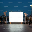 Blank illuminated billboard on urban rooftop at dusk