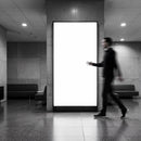 Blurred Man Walking Past Empty Lightbox in Modern Lobby