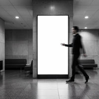 Blurred Man Walking Past Empty Lightbox in Modern Lobby