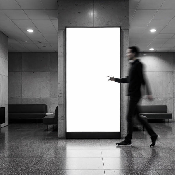 Blurred Man Walking Past Empty Lightbox in Modern Lobby JPG Mockup Image