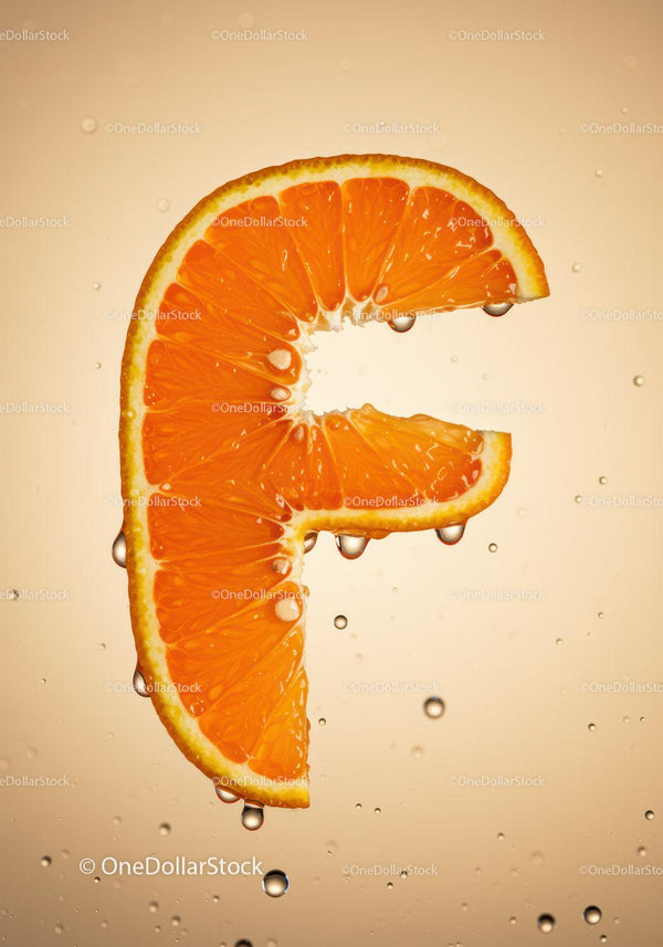 Fresh Orange Slice Shaped Like Letter F with Water Droplets