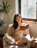 Smiling woman enjoying a book in bright cozy corner