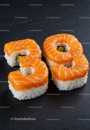 Number nine shaped salmon sushi rolls on black plate