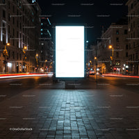 Illuminated blank billboard in city street at night