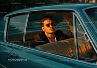 Stylish Man in Vintage Classic Car Wearing Sunglasses