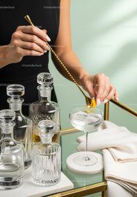 Elegant Mixologist Preparing Cocktail with Gold Bar Tools