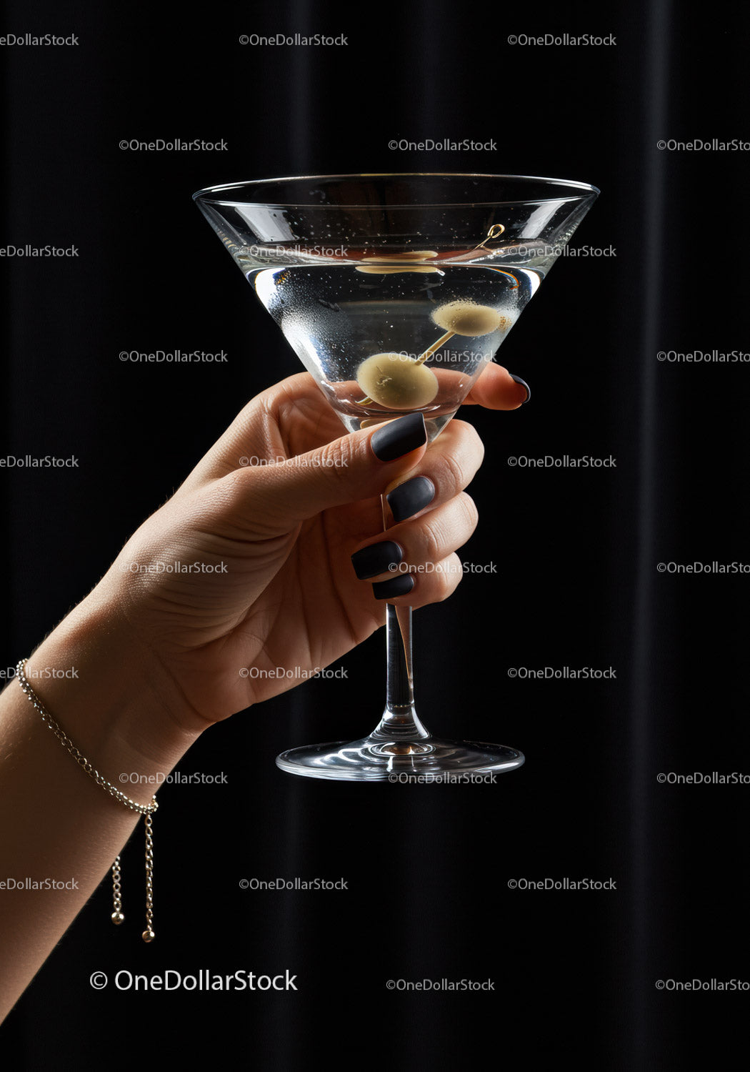 Woman Holding Classic Martini Glass with Olives