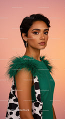 Elegant Woman in Green Dress with Feathered Details and Cow Print Tote