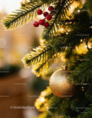 Golden Christmas ornament hanging on fir tree branch