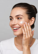 Young Woman Applying Skincare Cream for Flawless Skin