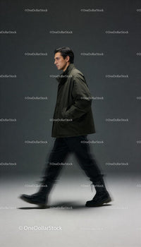 Man walking confidently in stylish dark green jacket