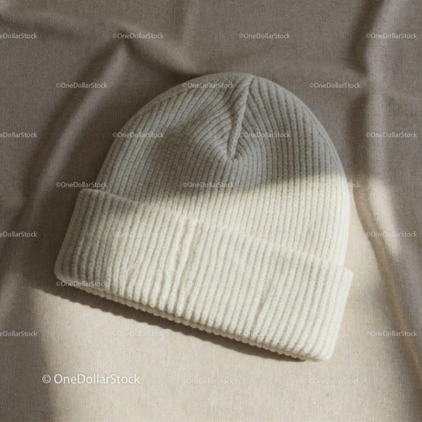 Cozy ribbed knit beanie hat on soft fabric background JPG Mockup Image
