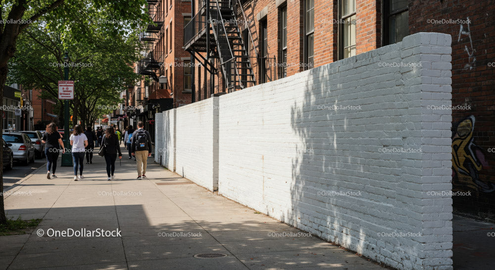 City Sidewalk with Pedestrians and Tree Shadows