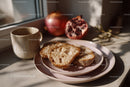 Fresh Bread with Coffee Mug and Pomegranate in Cozy Morning Setting