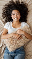 Smiling woman lying on bed with fluffy pillow