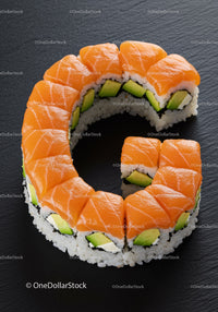 Fresh salmon avocado sushi roll on slate plate