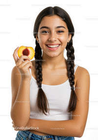 Young Woman Smiling and Holding Fresh Peach With Bright Expression
