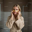 Woman with Gold Eye Masks in a Spa Setting for Facial Rejuvenation