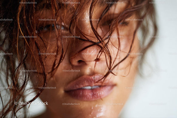 Close-up of a Woman with Wet Red Hair and Moisturized Skin