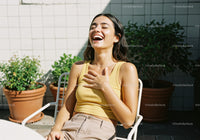 Joyful Woman Laughing Outdoors in Summer Sunlight