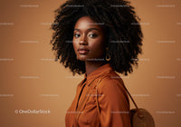Elegant African American Woman with Curly Hair in Brown Shirt in Studio