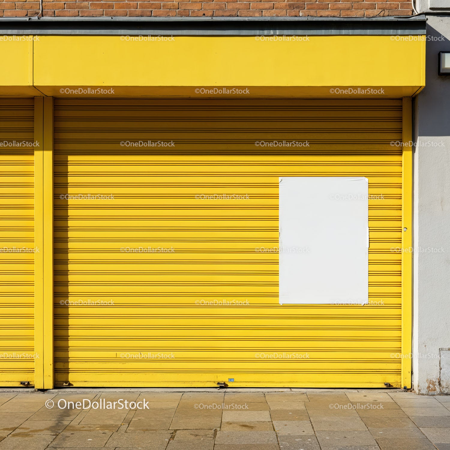 Bright yellow metal shutter with blank white poster