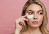 Young Woman Applying Under Eye Patch on Pink Background