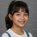 Young Girl with Braces Smiling Cheerfully in Studio Portrait