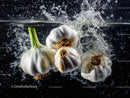 Fresh garlic bulbs submerged in water with splash effects