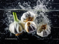 Fresh garlic bulbs submerged in water with splash effects