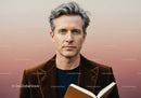 Stylish Adult Man Reading Book with Focused Expression