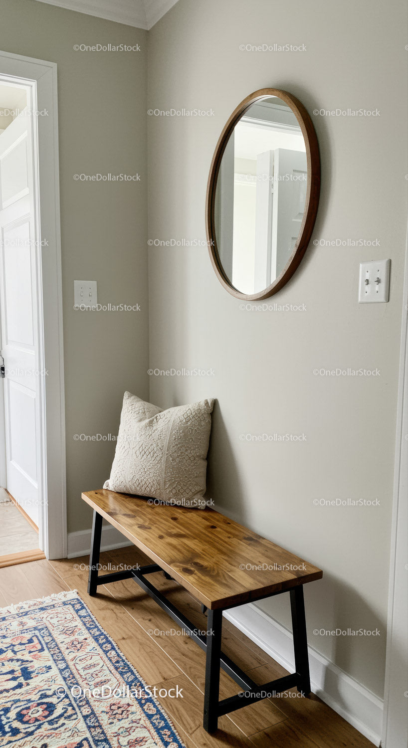 Minimalist Entryway with Wooden Bench and Oval Mirror in Neutral Colors