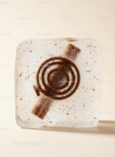 Rustic cinnamon candy embedded in clear ice cube