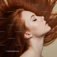 Profile of serene woman with flowing red hair
